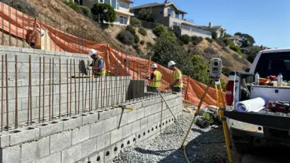Licensed structural contractors installing a reinforced CMU retaining wall in Topanga Canyon Los Angeles hillside