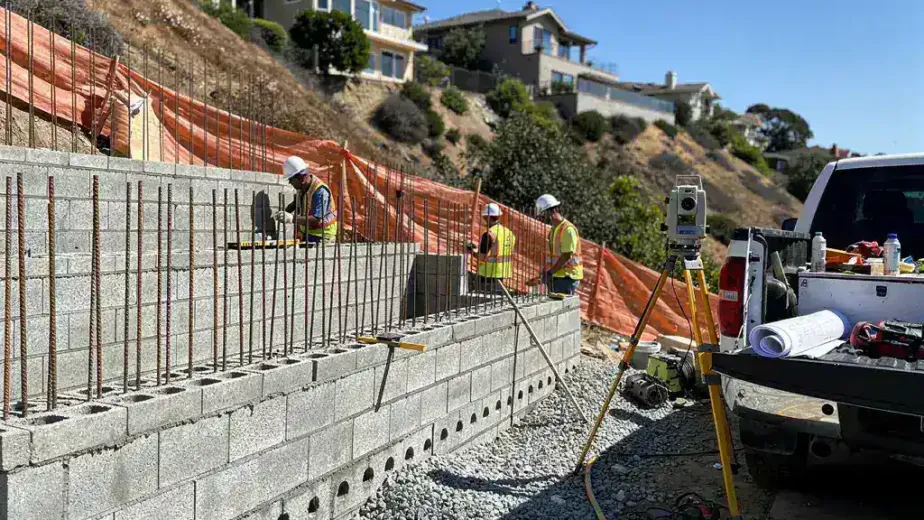 Licensed structural contractors installing a reinforced CMU retaining wall in Topanga Canyon Los Angeles hillside